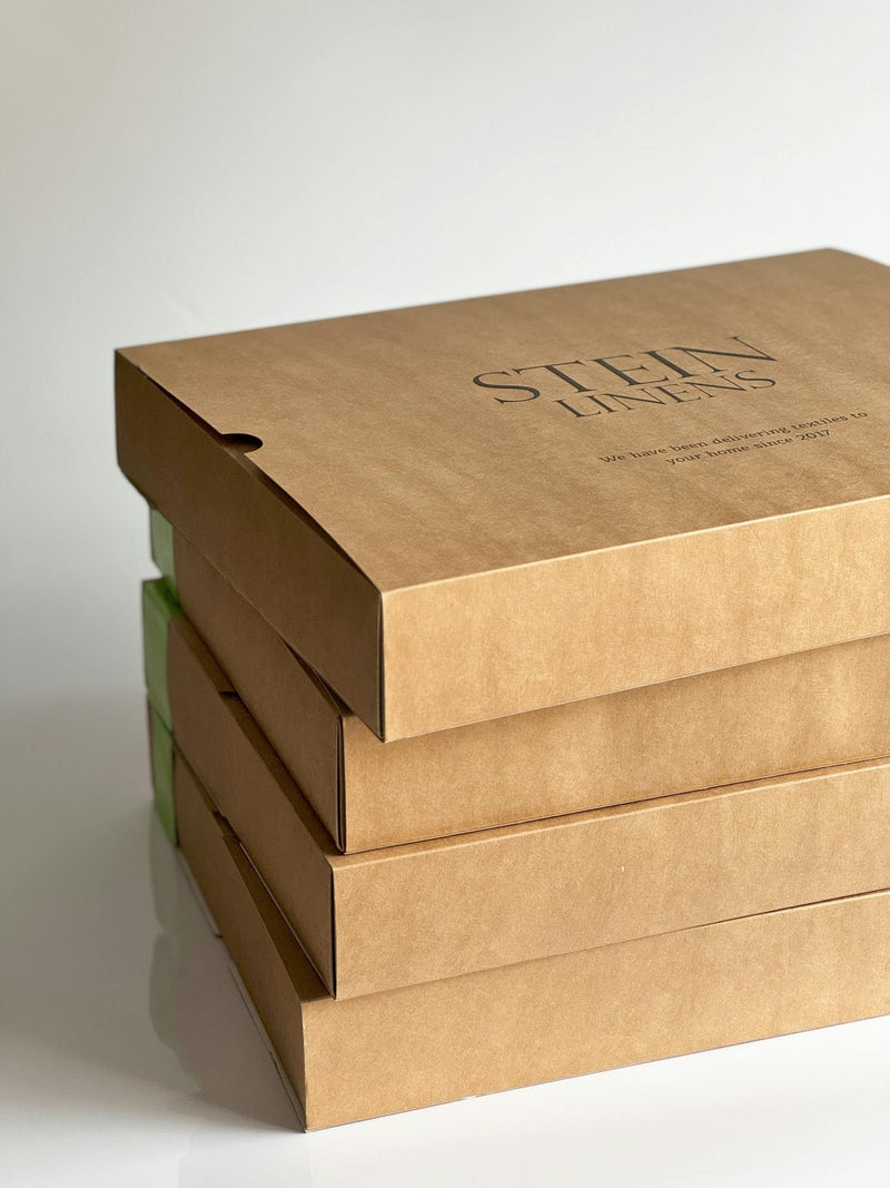Three stacked sustainable packaging boxes